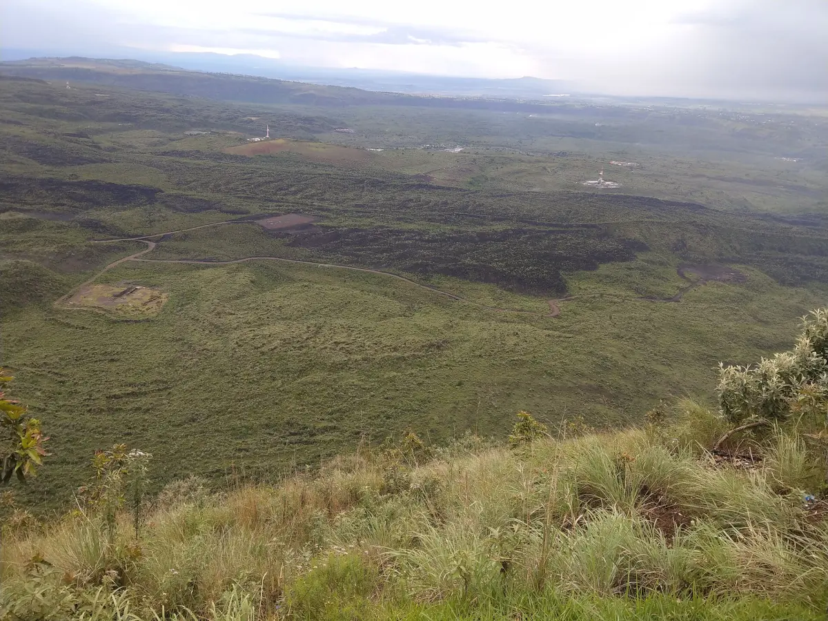 Dark lava fields spreading across the crater floor from the viewpoint