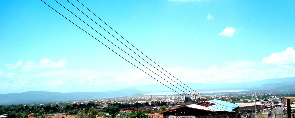 Wide view over Nakuru town from a hillside under blue sky